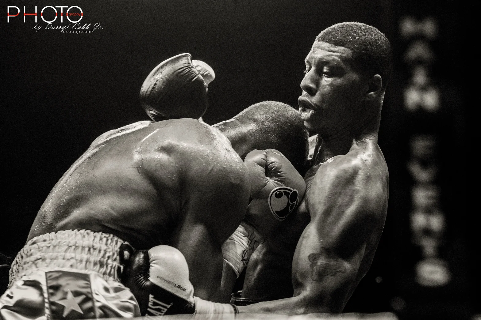 Black and white photograph of two boxers exchanging punches during a match.