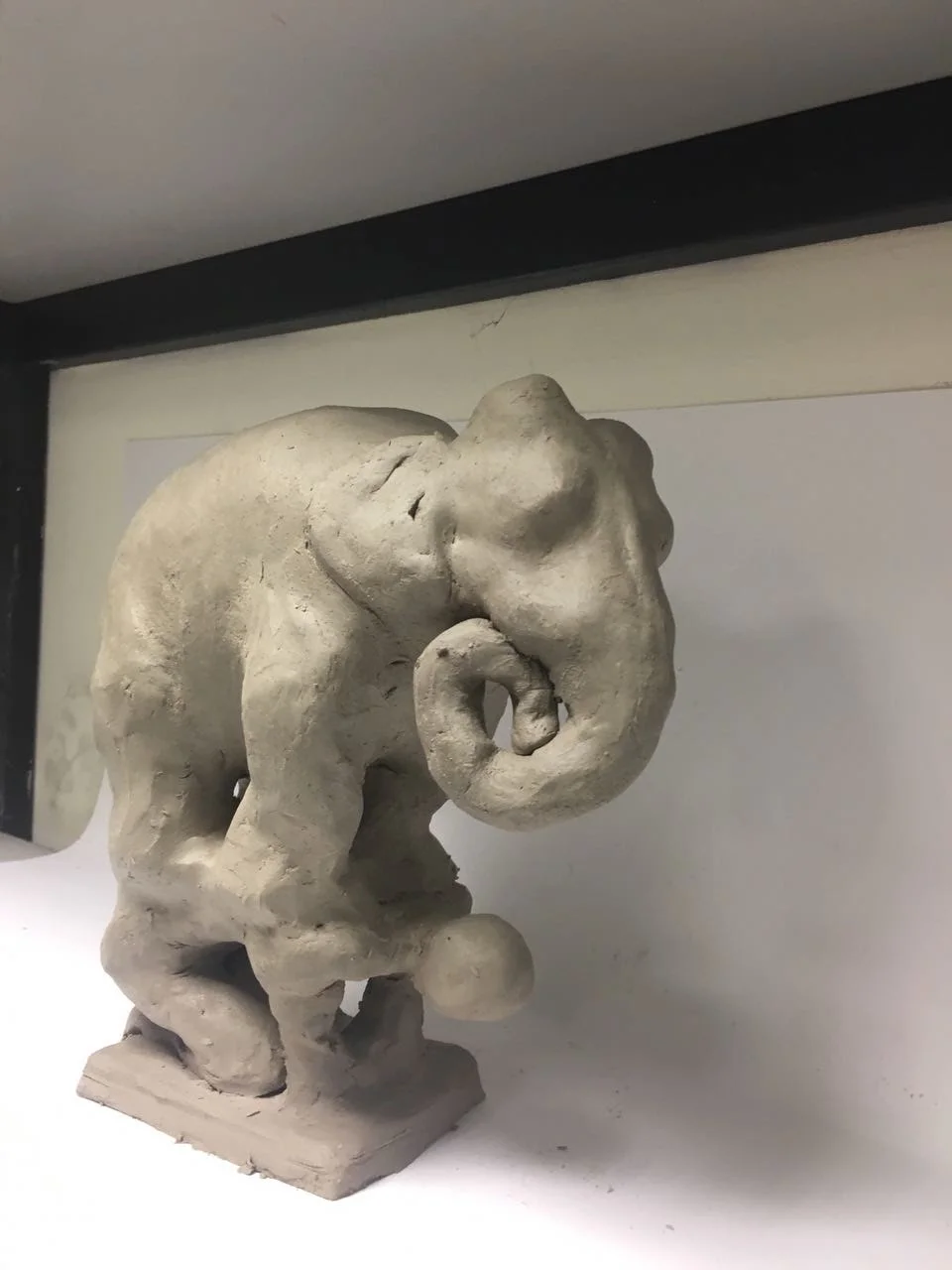 Textured tactile elephant sculpture displayed in the studio investigating raw form and grounded presence
