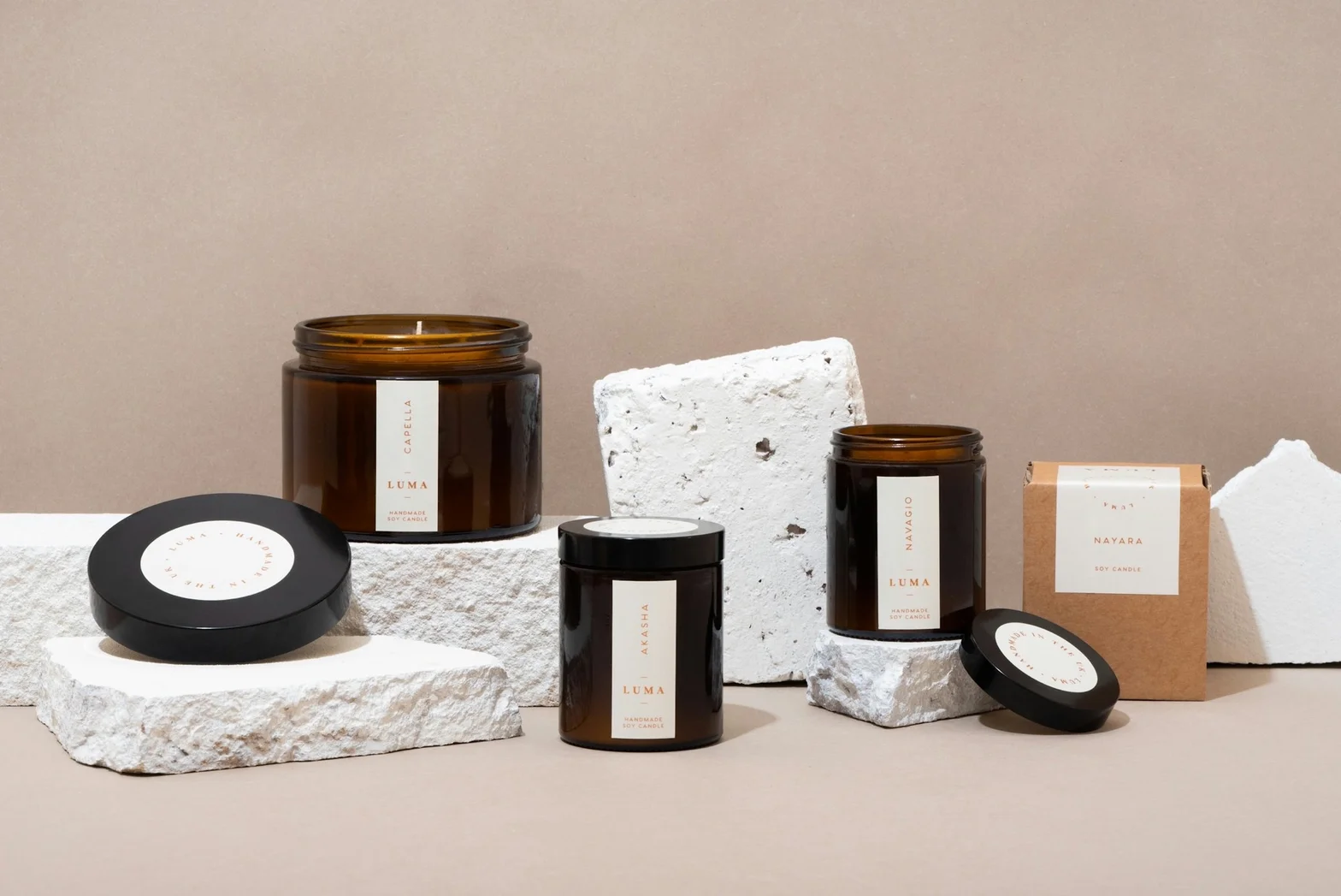 Soy candle collection with amber jars, black lids, and kraft packaging