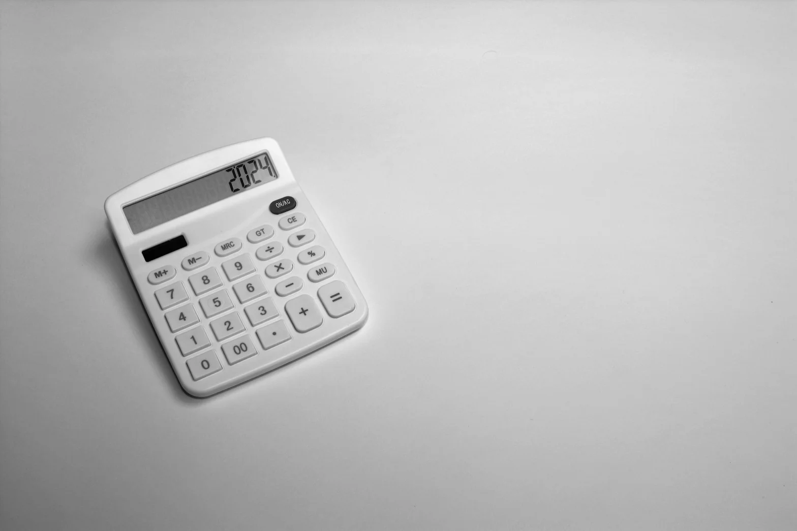 Desktop calculator on clean workspace representing transparent bookkeeping fees