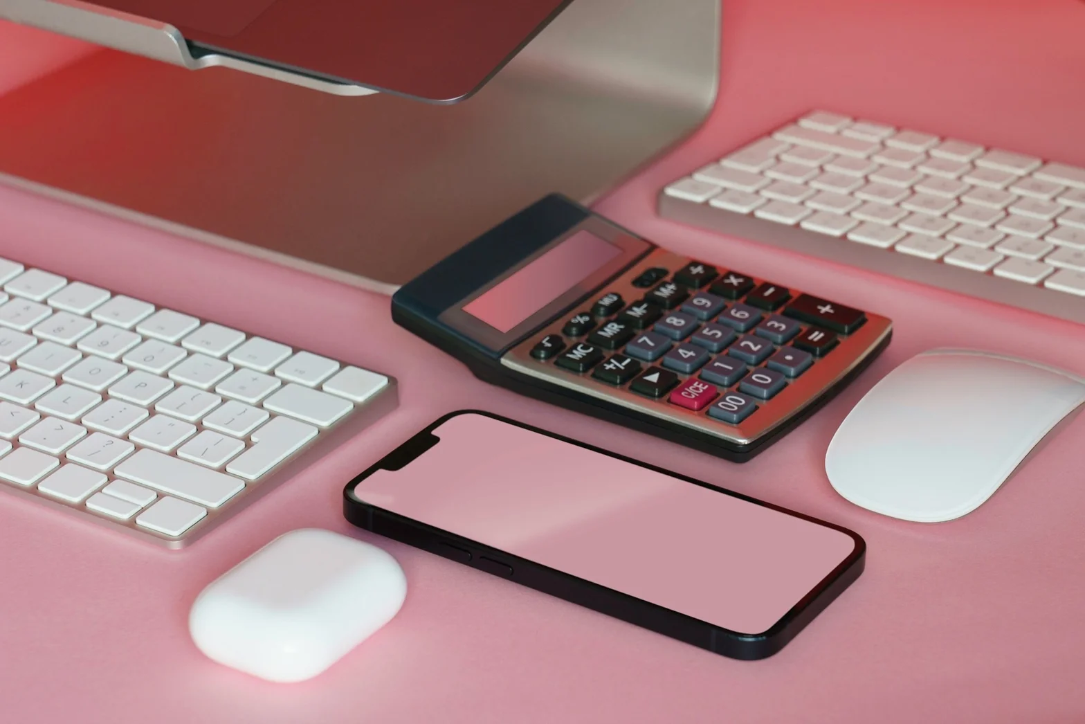 Organised digital workspace with laptop, keyboard, phone, and calculator for modern bookkeeping
