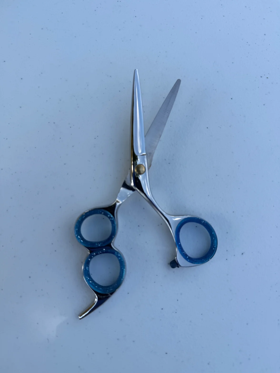 Handcrafted hair-cutting scissors with razor edge convex blade and silver finish