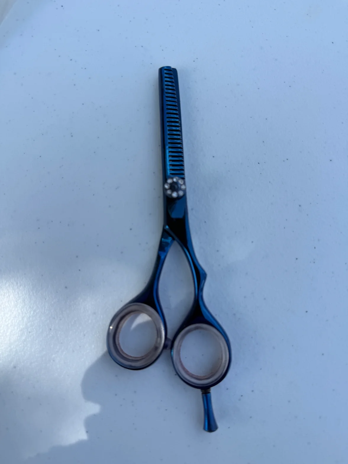Blue handcrafted hair scissors with balance adjustment dial