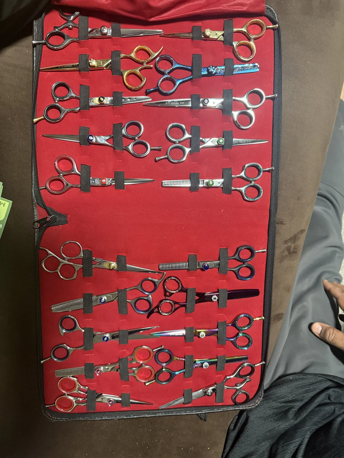 A full case of professional hair cutting shears, including cutting, thinning, and styling shears in various sizes and finishes