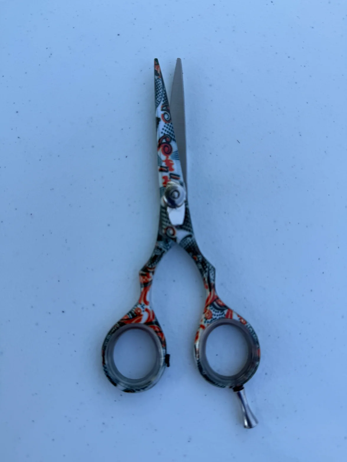 Decorative hair scissors with ornate detailing and sharp steel blades