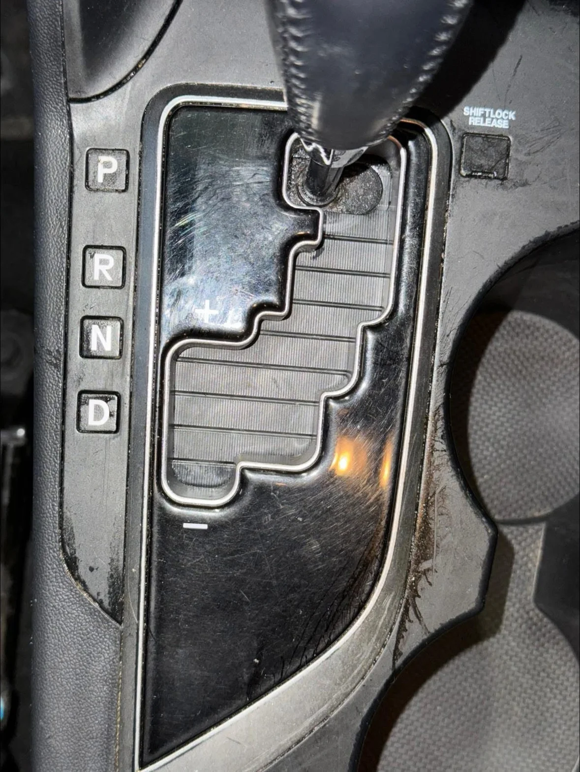 Close-up of automatic car gear selector and center console shift positions