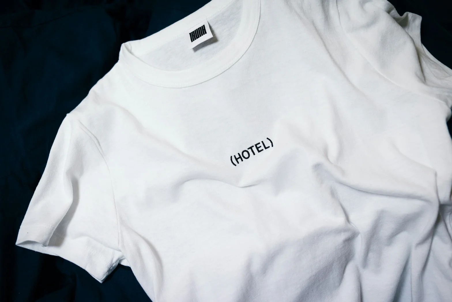 White short-sleeve T-shirt laid flat with subtle chest print